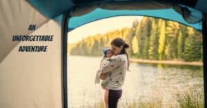 Camping with a baby outside a tent by the lake